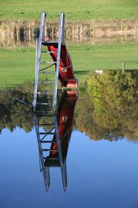 Boat moored on lake against sky