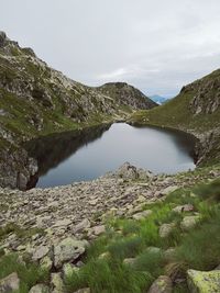 Scenic view of lake and mountains against sky