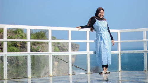 Full length of woman standing against sky