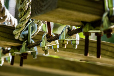 Close-up of ropes hanging on wood