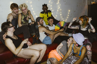 Group of multiracial non-binary friends having fun during party at nightclub