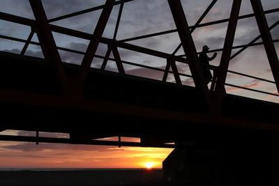 Low angle view of bridge against sky during sunset