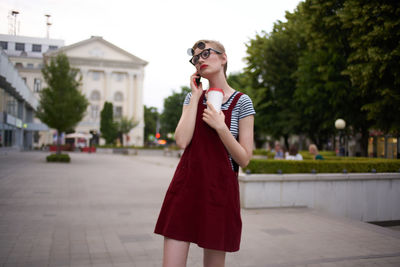 Young woman wearing sunglasses standing outdoors