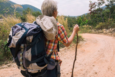 Rear view of men walking on mountain road