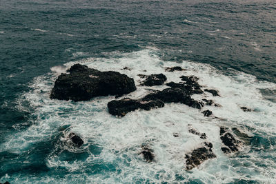 High angle view of rocks in sea