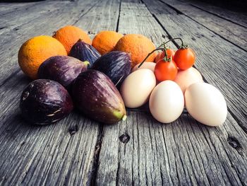 Close-up of fresh vegetables and fruits with eggs on table