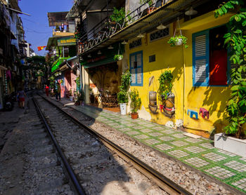 Railroad tracks amidst buildings in city