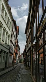 Buildings in city against cloudy sky