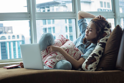 Low angle view of woman using mobile phone