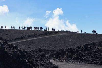 People on beach against sky