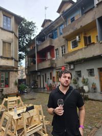 Man drinking wine outdoors cloudy weather