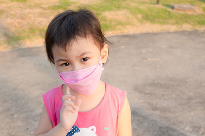 3 years old asian girl in protective medical masks during coronavirus pandemic prevention.