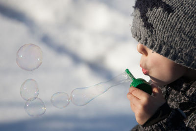 Close-up of child blowing bubbles