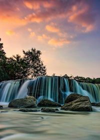 View of waterfall against sky during sunset