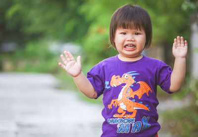 Portrait of cute boy standing in park