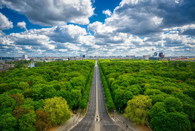 Road amidst green landscape against sky