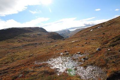 Scenic view of landscape and mountains against sky