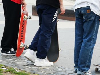 Low section of people standing on footpath