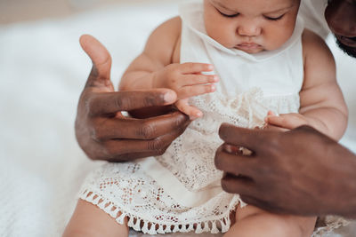 Midsection of mother holding girl