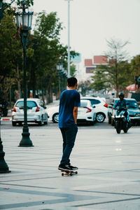 Rear view of man walking on city street