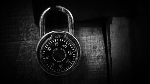 Close-up of padlocks with numbers hanging on door