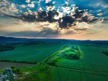 Scenic view of agricultural field against sky during sunset