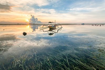 Scenic view of sea against sky at sunset