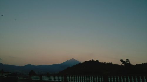 Scenic view of silhouette mountains against clear sky