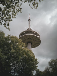 Low angle view of tower and building against sky