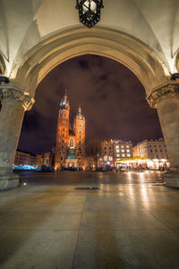 St marys church seen through arch in city at night