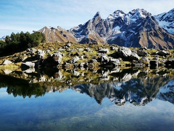 Scenic view of lake and mountains against sky