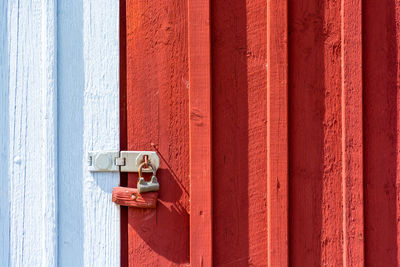 Full frame shot of red door with text on wall