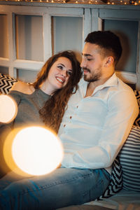 Young couple sitting in corridor