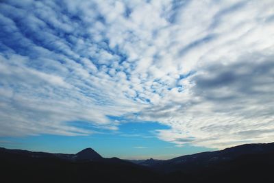 Scenic view of silhouette mountains against sky