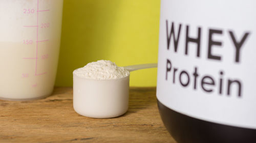 Close-up of whey protein in spoon on table