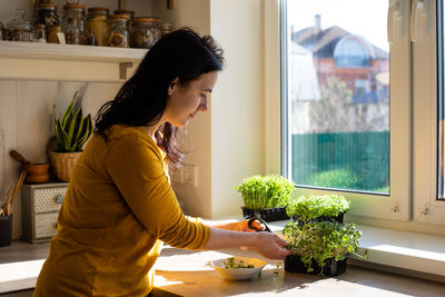 Woman looking at window at home