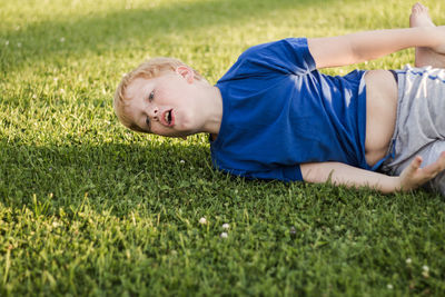 Boy playing on grassy field