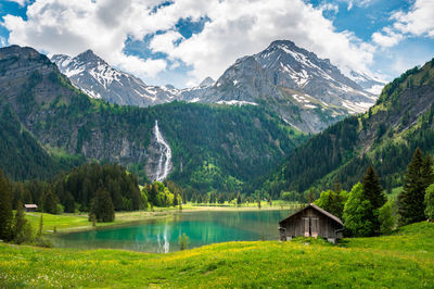 Scenic view of lake by mountains against sky