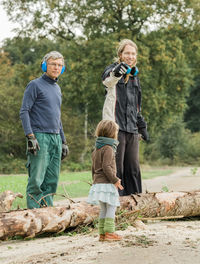 Full length of family standing on field