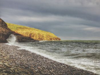 Scenic view of sea against cloudy sky