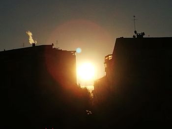 Low angle view of silhouette building against sky during sunset