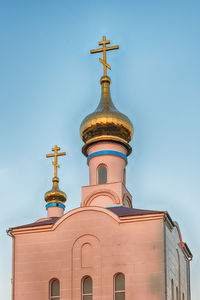 Low angle view of traditional building against clear blue sky