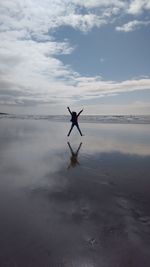 Man on beach against sky