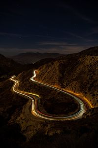 High angle view of light trails on road against sky at night