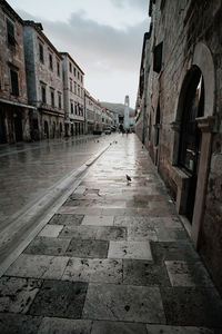 Street amidst buildings in city against sky