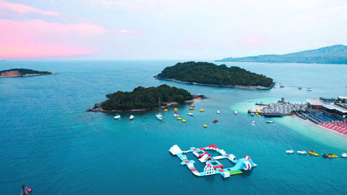 High angle view of boats in sea against sky during sunset