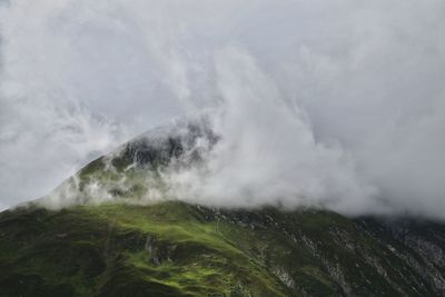 Scenic view of waterfall against sky