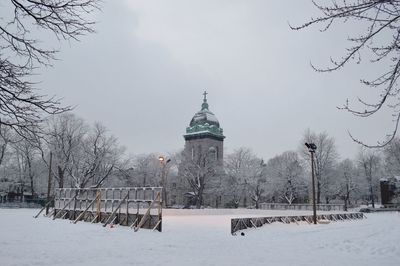 Low angle view of church amidst trees during winter