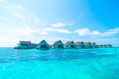 View of swimming pool by sea against sky