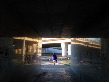 Full length of woman walking in tunnel